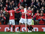 Marouane Fellaini of Manchester United is congratulated by teammates Juan Mata of Manchester United and Wayne Rooney of Manchester United after scoring the opening goal during the Barclays Premier League match between Manchester United and Tottenham Hotsp