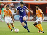 Kaka #10 of the Orlando City SC moves with the ball between Luis Garrido #8 and Jermaine Taylor #4 of the Houston Dynamo during their game at BBVA Compass Stadium on March 13, 2015