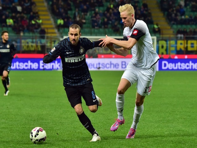 Inter Milan's forward from Argentina Rodrigo Palacio fights for the ball with Cesena's midfielder from Iceland Hordur Bjorgvin Magnusson (R) during the Serie A football match on March 15, 2015