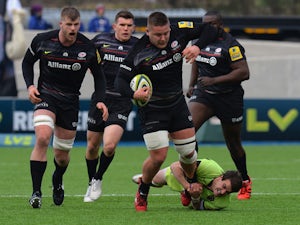 Richard Barrington of Saracens is tackled by Lee Dickson of Northampton Saints during the LV= Cup Semi Final match between Saracens and Northampton Saints at Allianz Park on March 14, 2015