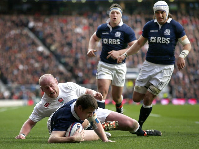 Mark Bennett of Scotland dives over the line to score a try under pressure from Dan Cole of England during the RBS Six Nations match between England and Scotland at Twickenham Stadium on March 14, 2015