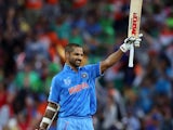India's Shikhar Dhawan celebrates his century during the Pool B Cricket World Cup match between India and Ireland at Seddon Park in Hamilton on March 10, 2015