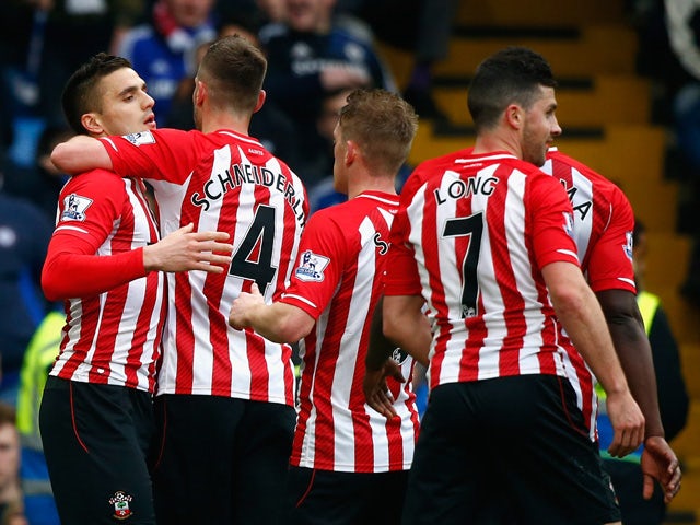 Dusan Tadic of Southampton celebrates scoring their first goal with Morgan Schneiderlin and team mates during the Barclays Premier League match between Chelsea and Southampton at Stamford Bridge on March 15, 2015