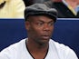 Former French football international, Sylvain Wiltord (C) watches the action between Roger Federer of Switzerland and Jeremy Chardy  on October 29, 2014