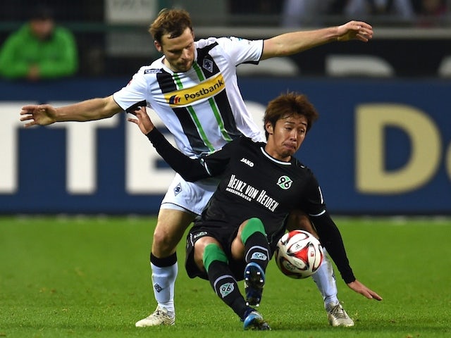 Moenchengladbach's defender Tony Jantschke (L) and Hanover's Japanese midfielder Hiroshi Kiyotake vie for the ball during the German first division Bundesliga football match