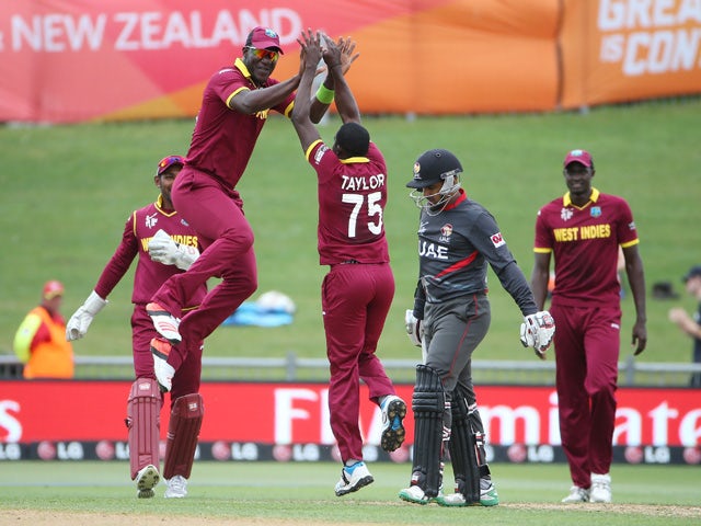 West Indies bowler Jerome Taylor is congratulated by Darren Sammy after he took the wicket of United Arab Emirates batsman Khurram Khan during the Pool B 2015 Cricket World Cup match between West Indies and United Arab Emirates at McLean Park in Napier on