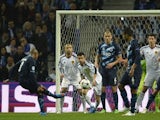 Porto's Algerian midfielder Yacine Brahimi (L) kicks the ball to score a goal during the UEFA Champions League round of 16 second leg football match against Basel on March 10, 2015