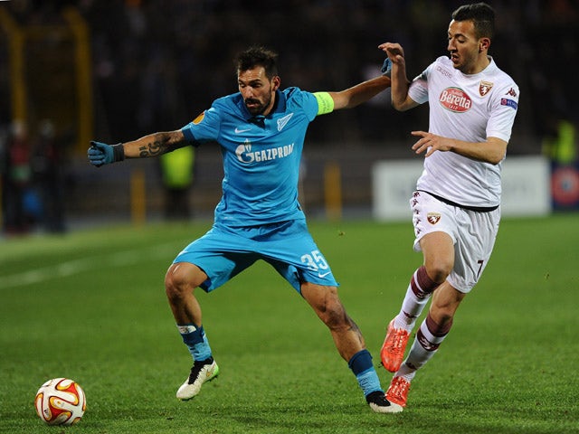 Zenit's Portuguese midfielder Miguel Danny vies for the ball with Torino's Moroccan midfielder Omar El Kaddouri during the UEFA Europa League round of 16 football match between FC Zenit and FC Torino in Saint Petersburg on March 12, 2015