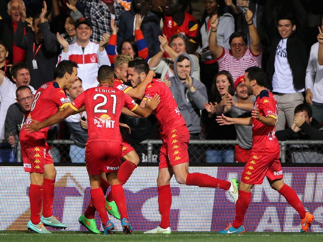 Dylan McGowan of United celebrates with his team mates after scoring during the round 22 A-League match between Adelaide United and Melbourne Victory at Coopers Stadium on March 21, 2015