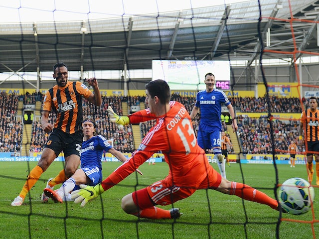Ahmed Elmohamady of Hull City (27) shoots past goalkeeper Thibaut Courtois of Chelsea to score their first goal during the Barclays Premier League match on March 22, 2015