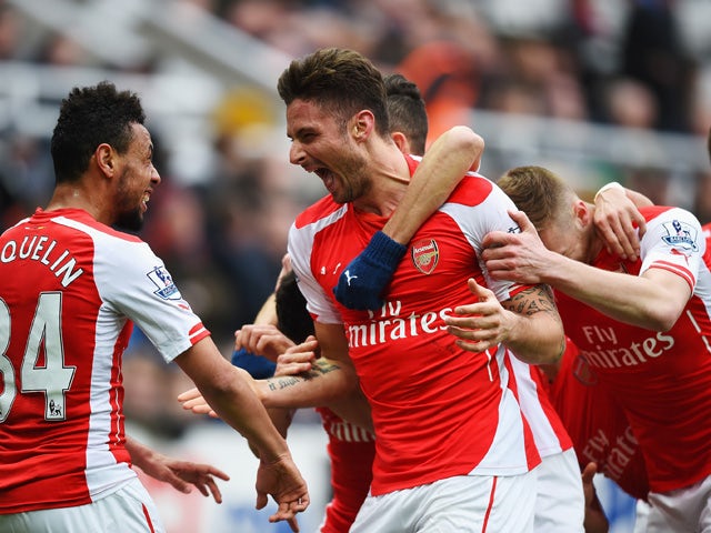 Olivier Giroud of Arsenal celebrates scoring his second goal with Francis Coquelin during the Barclays Premier League match between Newcastle United and Arsenal at St James' Park on March 21, 2015