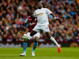 Jores Okore of Aston Villa and Bafetibis Gomis of Swansea City compete for the ball during the Barclays Premier League match between Aston Villa and Swansea City at Villa Park on March 21, 2015 
