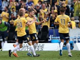 Mariners team mates celebrate a goal by Nick Montgomery during the round 22 A-League match between the Central Coast Mariners and the Perth Glory at Central Coast Stadium on March 22, 2015