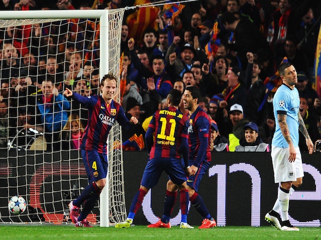 Ivan Rakitic of Barcelona (L) celebrates scoring the opening goal with Neymar and Luis Suarez of Barcelona during the UEFA Champions League Round of 16 second leg match against Manchester City on March 18, 2015