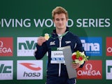 Jack Laugher poses with his gold medal after winning the men's 3m in Dubai on March 20, 2015