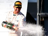 Lewis Hamilton of Great Britain and Mercedes GP celebrates on the podium after winning the Australian Formula One Grand Prix at Albert Park on March 15, 2015