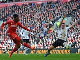 Liverpool's English striker Daniel Sturridge shoots past Manchester United's English defender Phil Jones (R) to score Liverpool's first goal during the English Premier League football match between Liverpool and Manchester United at Anfield in Liverpool, 