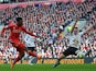 Liverpool's English striker Daniel Sturridge shoots past Manchester United's English defender Phil Jones (R) to score Liverpool's first goal during the English Premier League football match between Liverpool and Manchester United at Anfield in Liverpool, 