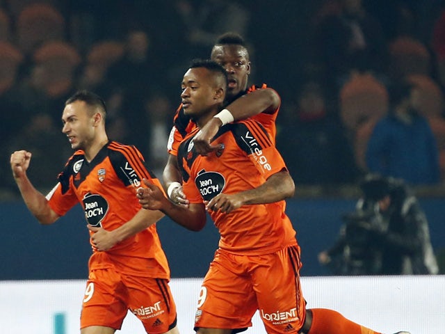 Lorient's Ghanaian forward Jordan Ayew celebrates with teammates after scoring a goal during the French L1 football match between Paris Saint-Germain (PSG) and FC Lorient on March 20, 2015