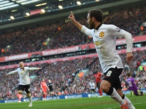 Manchester United's Spanish midfielder Juan Mata celebrates after scoring the opening goal of the English Premier League football match between Liverpool and Manchester United at Anfield in Liverpool, north west England on March 22, 2015