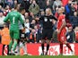 Referee Martin Atkinson separates Manchester United's Spanish goalkeeper David de Gea and Liverpool's Slovakian defender Martin Skrtel during the English Premier League football match between Liverpool and Manchester United at Anfield in Liverpool, north 