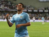 Marcos Lopes of Manchester City celebrates after scoring his teams first goal during the friendly match between Al Ain and Manchester City at Hazza bin Zayed Stadium on May 15, 2014