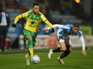Nathan Redmond of Norwich City takes on Jake Carroll of Huddersfield Town during the Sky Bet Championship match on March 17, 2015