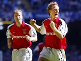 Arsenal's Dennis Bergkamp and Ray Parlour celebrate after Parlour scored the opening goal during the The F.A Cup final against Chelsea at The Millenium Stadium in Cardiff 04 May 2002