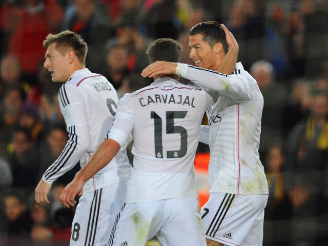 Cristiano Ronaldo of Real Madrid CF celebrates with Daniel Carvajal as he scores their first and equalising goal during the La Liga match between FC Barcelona and Real Madrid CF at Camp Nou on March 22, 2015