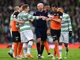 Referee Bobby Madden keeps Kris Commons of Celtic and Ryan McGowan of Dundee United apart during the Scottish League Cup Final between Dundee United and Celtic at Hamden Park on March 15, 2015