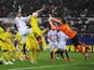 Sergio Asenjo of Villarreal fists the ball away from Vicente Iborra of FC Sevilla during the UEFA Europa League Round of 16, Second Leg match between FC Sevilla and Villarreal CF at Estadio Ramon Sanchez Pizjuan on March 19, 2015