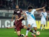 Emiliano Moretti of Torino FC competes for the ball with Axel Witsel of FC Zenit during the UEFA Europa League Round of 16 match between Torino FC and FC Zenit on March 19, 2015