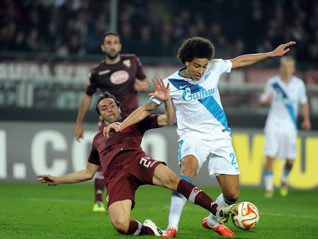 Emiliano Moretti of Torino FC competes for the ball with Axel Witsel of FC Zenit during the UEFA Europa League Round of 16 match between Torino FC and FC Zenit on March 19, 2015