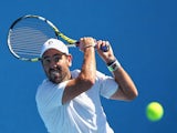 Wayne Odesnik of USA plays a backhand in his qualifying match against Vincent Millot of France for 2015 Australian Open at Melbourne Park on January 16, 2015