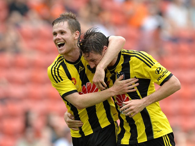 Nathan Burns of Wellington Phoenix is congratulated by team mate Michael McGlinchey after scoring a goal during the round 22 A-League match between the Brisbane Roar and the Wellington Phoenix at Suncorp Stadium on March 22, 2015
