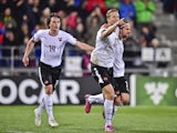 Austria's Marc Janko celebrates with teammates Martin Harnik and Julian Baumgartlinger after scoring the second goal of the match during the Euro 2016 qualifying football match between Liechtenstein and Austria at the Rheinpark stadium in Vaduz on March 2