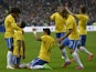 Brazil's midfielder Luiz Gustavo is congratulated by teammates after scoring a goal during the friendly football match France vs Brazil, on March 26, 2015