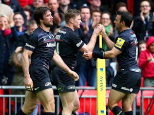 Chris Ashton (C) of Saracens is congratulated by teammate Neil de Kock (R) of Saracens after scoring his team's second try during the Aviva Premiership match between Saracens and Harlequins at Wembley Stadium on March 28, 2015