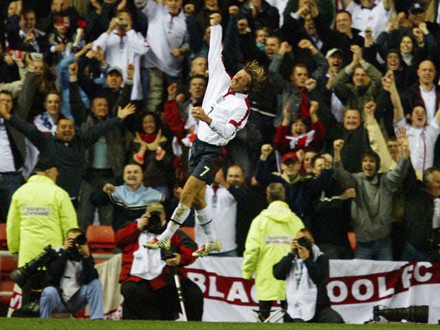 David Beckham of England celebrates in front of the England fans during the UEFA Euro 2004 Qualifying match between England and Turkey held on April 2, 2003