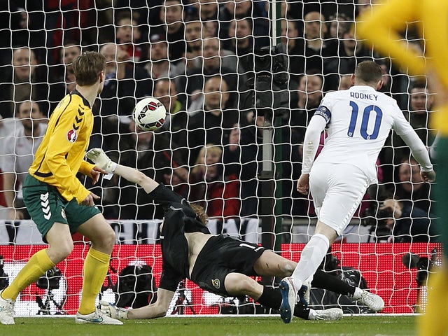 England's striker Wayne Rooney scores his team's first goal during a Euro 2016 Group E qualifying football match between England and Lithuania at Wembley Stadium in north London on March 27, 2015