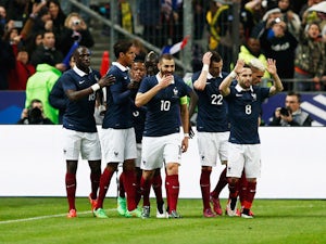 Raphael Varane #4 of France celebrates with team mates after scoring the first goal of the game during the International Friendly match between France and Brazil at the Stade de France on March 26, 2015
