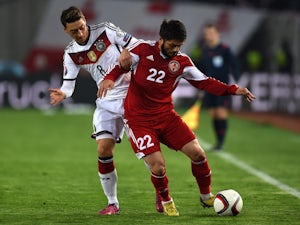 Georgia's Giorgi Navalovski (R) and Germany's midfielder Mesut Ozil vie for the ball during the Euro 2016 qualifying football match between Georgia and Germany at the Boris-Paitschadse-Stadium in Tbilisi , Georgia on March 29, 2015