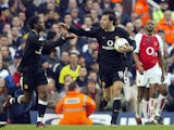 Manchester United's Louis Saha (L) is congratulated by teammate Ruud Van Nistelrooy (C) watched by Arsenal captain Patrick Vieira after scoring an equalizer during their FA Premier League clash at Highbury in London, 28 March 2004