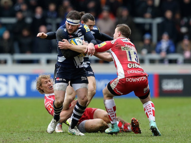 Mark Cueto of Sale Sharks is tackled by Brendan Macken of Gloucester during the Aviva Premiership rugby match between Sale Sharks and Gloucester Rugby at AJ Bell Stadium on March 29, 2015
