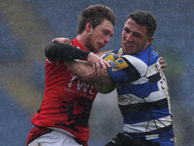 Nic Reynolds of London Welsh tackles Sam Burgess of Bath during the Aviva Premiership match between London Welsh and Bath Rugby at Kassam Stadium on March 29, 2015 