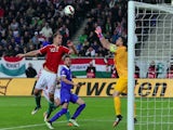 Greece's goalkeeper Orestis Karnezis (R) and midfielder Andreas Samaris (C) vie with Hungary's defender Roland Juhasz during the Euro 2016 qualifying football match between Hungary and Greece at the Groupama Arena in Budapest on March 29, 2015