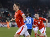 Switzerland's defender Fabian Schaer celebrates with teammate forward Josip Drmic after he scored the first goal during the Euro 2016 qualifying football match between Switzerland and Estonia at the Swissporarena stadium in Lucerne on March 27, 2015