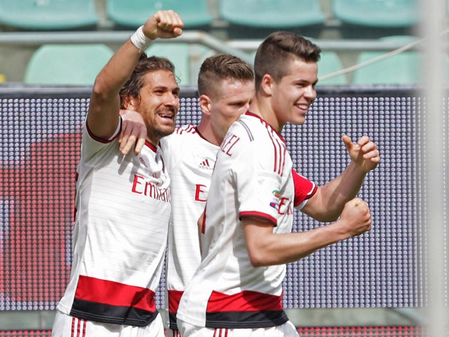 Milan's Alessio Cerci is congratulated by teammates after scoring during the Italian Serie A football match Palermo vs Milan at Renzo Barbera Stadium in Palermo on April 4, 2015