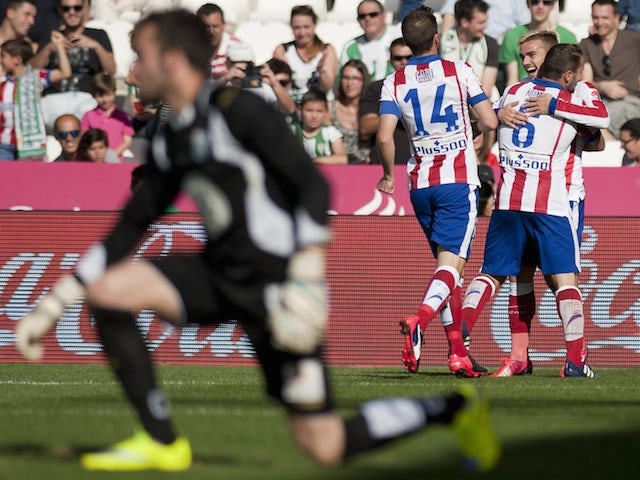 Atletico Madrid's French forward Antoine Griezmann (backR) celebrates after scoring with his teammates during the Spanish league football match Cordoba CF vs Club Atletico de Madrid at El Nuevo Arcangel stadium in Cordoba on April 4, 2015
