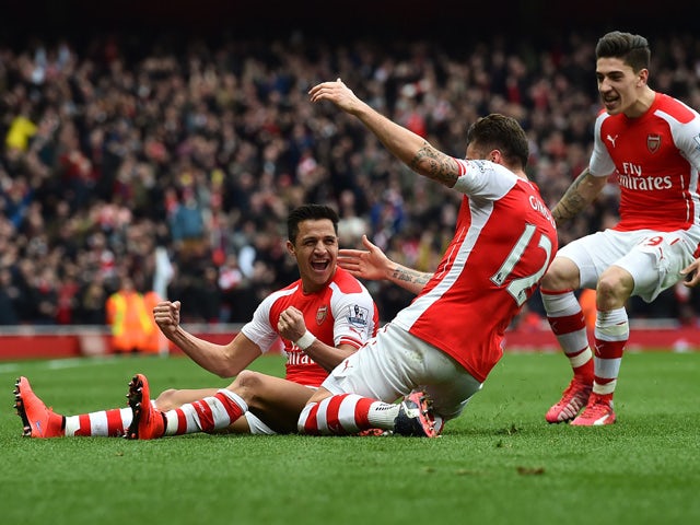 Arsenal's Chilean striker Alexis Sanchez celebrates with teammates after scoring their third goal during the English Premier League football match between Arsenal and Liverpool at the Emirates Stadium in London on April 4, 2015